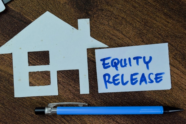 Image showing a cutout house with a note beside it saying "equity release" expounding the benefits of equity release