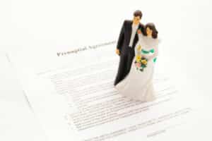 Image showing a model of a couple in wedding attire standing on a pre-nuptial agreement