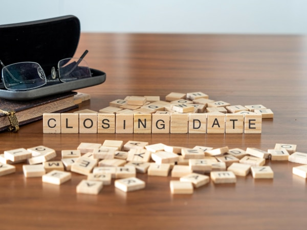 Scrabble blocks spelling out a Closing Date
