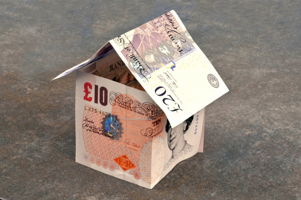 Image showing a house made of £10 notes signifying the value locked in a house that can be freed up using equity release