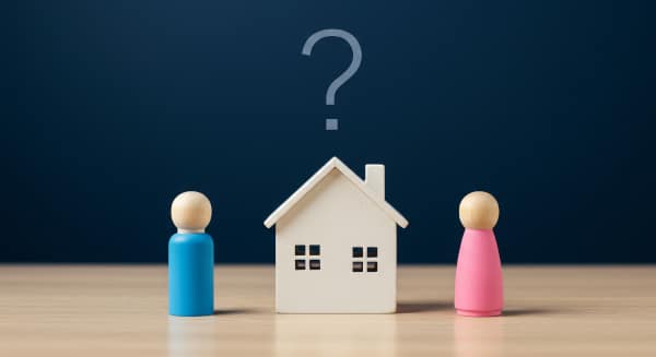 Model wooden house wiht a question mark over it with a blue figure on one side and a pink figure on the other representing the challenge of resolving financial provision on divorce