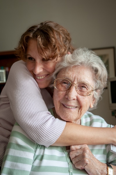 Daughter hugs her mother for whom she has a guardianship order