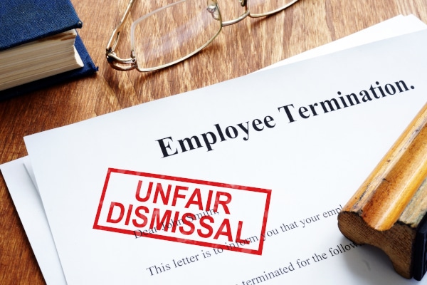 Employee termination letter with "Unfair Dismissal" in red stamped on it.