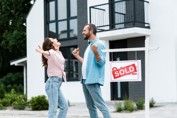 Couple celebrating the sale of their house