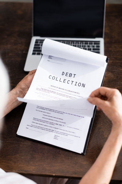 Person holding a debt collection letter in a debt recovery action