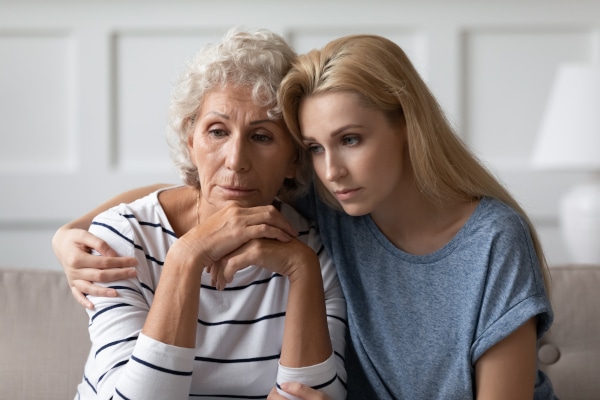 Daughter hugs her mother for whom she holds a guardianship order
