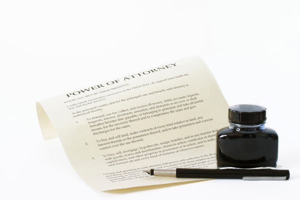 Power of Attorney document sitting beside a fountain pen and bottle of ink