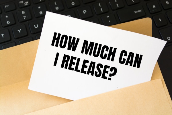 Photo of a brown folder sitting on a black keyboard with a piece of paper with teh words "How much can I release?" printed on it