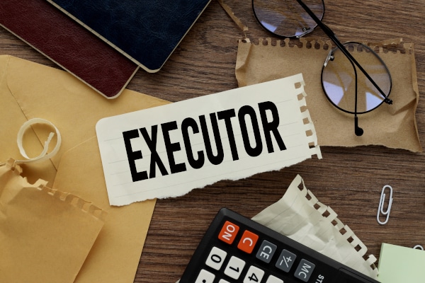 Image of a notebook with the word "Executor" written on it and required fore dealing with Estates