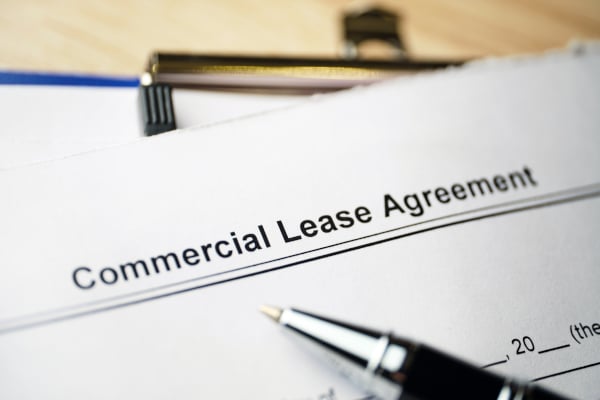 Commercial lease agreement with a pen sitting on top