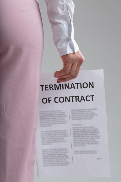 Woman holding a termination of employment contract notice