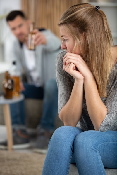 Worried woman being abused by her drunk husband