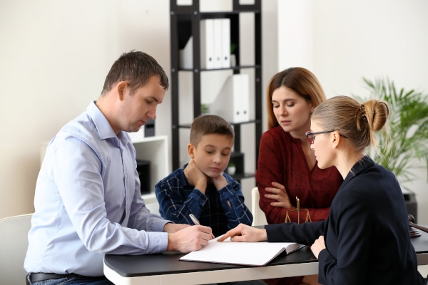 Parents agreeing contact with their child in the presence of a lawyer whilst arranging co-parenting at Christmas in Scotland