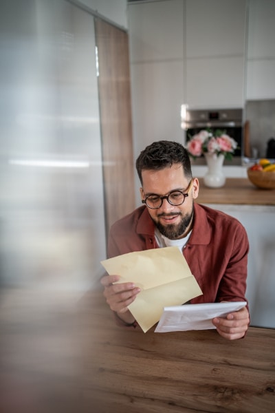 Man reading a letter which  purports to change a Will
