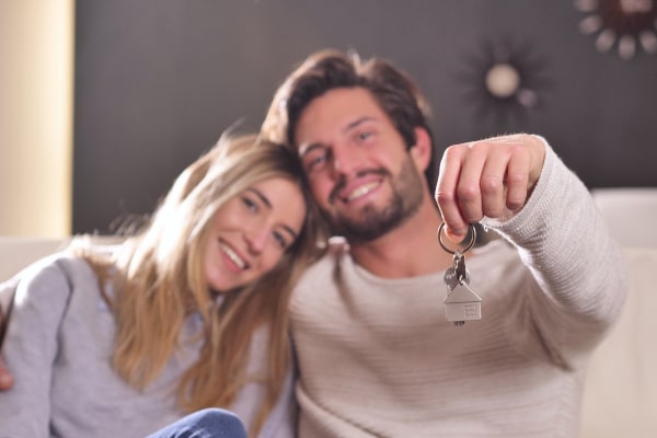 Unmarried couple with house keys planning their future together