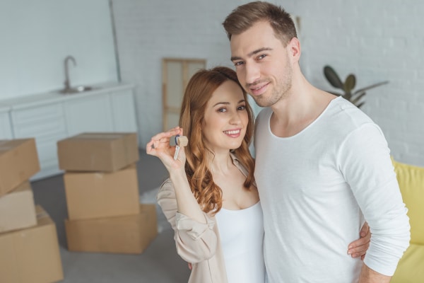 Unmarried couple holding the keys to their new Scottish home