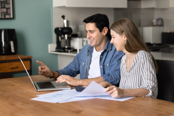 A couple working out the costs of buying their first home with a shared-equity deposit scheme