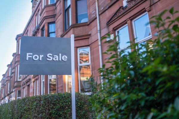 A sold board outside a Scottish home, illustrating repaying the First Home Fund share on sale
