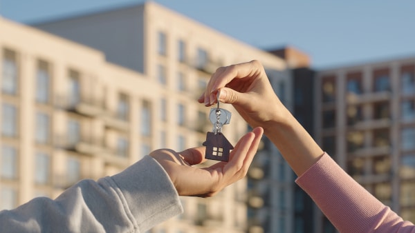 New homeowners receiving the keys on the date of entry after buying their first home in Scotland