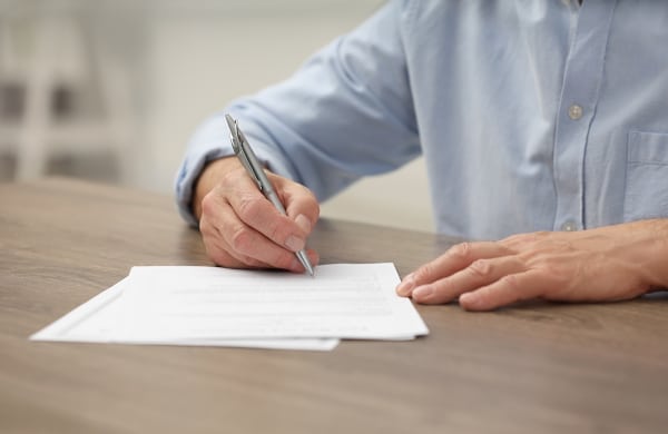Granter signing a Scottish Power of Attorney document in a solicitor’s office