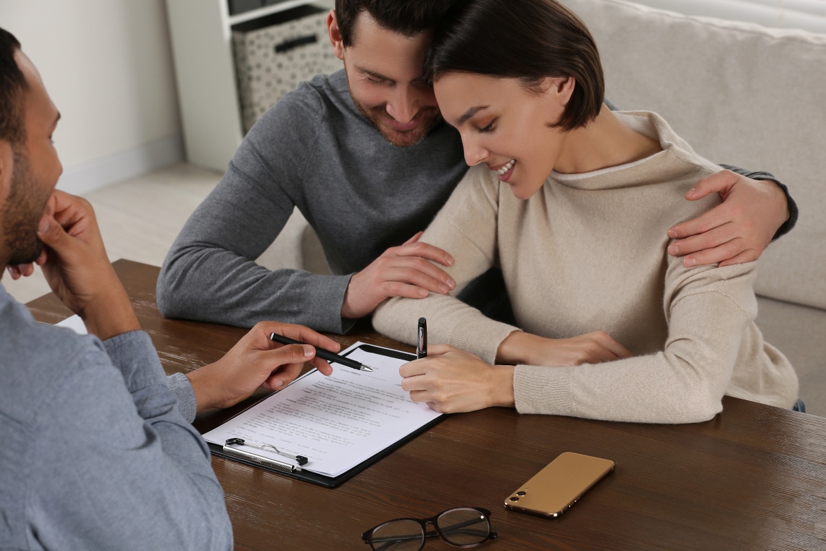 Client signing a Will with a solicitor during Will Aid month in November