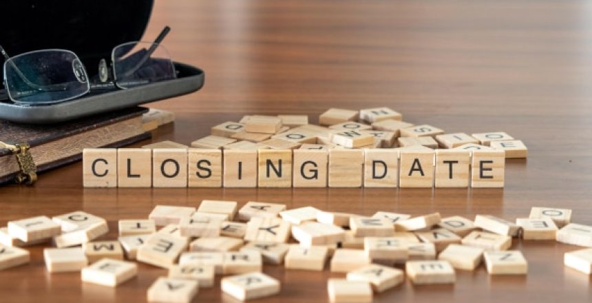 Scrabble blocks spelling out a Closing Date