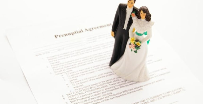 Image showing a model of a couple in wedding attire standing on a pre-nuptial agreement